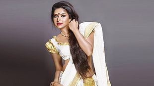 woman wearing ghagra choli dress on gray background