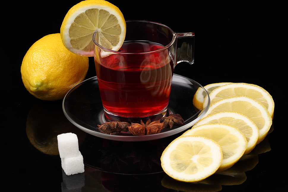 sliced lemon in clear glass HD wallpaper