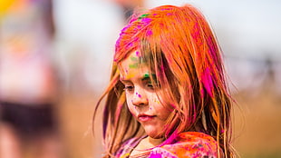 selective photography of blonde haired girl covered in paint