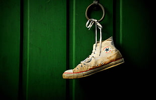 unpaired white Converse All Star high-top sneaker