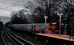 black and white metal trailer, train, light trails, selective coloring, motion blur