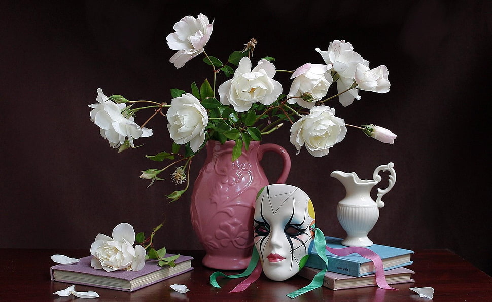 white Rose flowers in pink ceramic vase with books and mask HD wallpaper