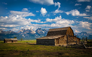 brown wooden barn under cloudy sky during daytime
