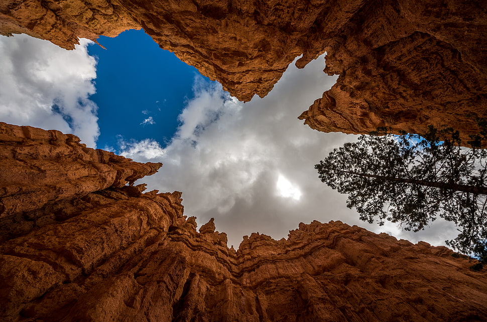 low angle photo of rugged cliff with cloudy sky during daytime, bryce canyon, usa HD wallpaper