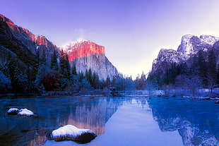 landscape photo of body of water with mountains background