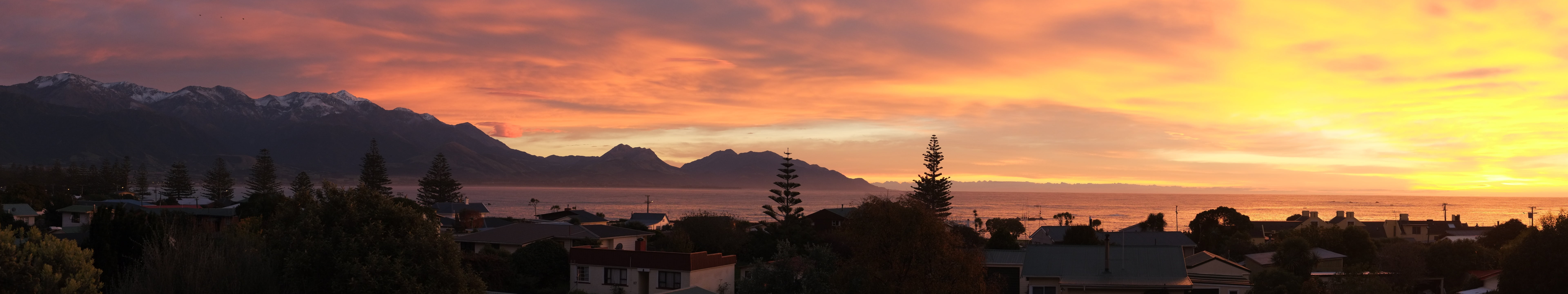 silhouette of buildings, dusk, water, mountains, New Zealand