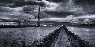grayscale photography of bridge above body of water