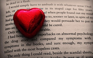 heart shaped accessory on top of book HD wallpaper