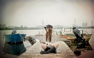 woman siting on a concrete dock HD wallpaper