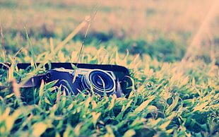 black DSLR camera on green grass