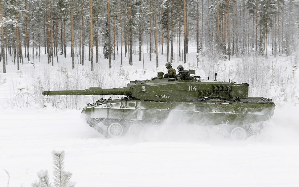green armored tank running on snow field HD wallpaper