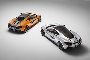 two orange and silver coupes digital wallpaper
