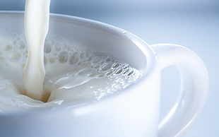 white liquid pouring in white ceramic cup HD wallpaper