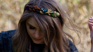 closeup photo of woman wearing braided headband
