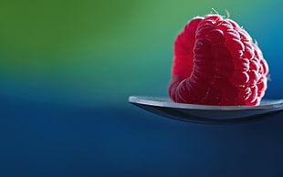 pink berry on spoon