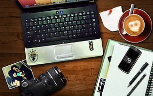 flat lay photography of black and gray laptop computer, black DSLR camera, and latte with heart art