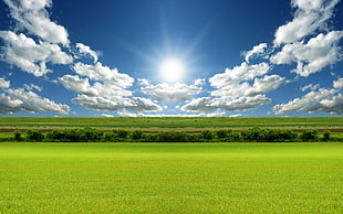 landscape photography of green grass field under white clouds and blue sky during daytime
