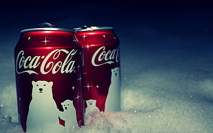 two red Coca-Cola cans, Coca-Cola