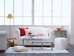 coffee tables between sofa set near window inside room at daytime