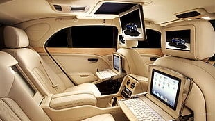 brown car seats with laptops