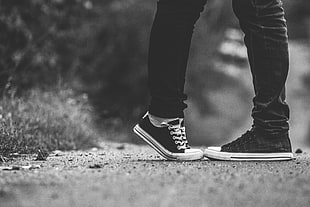 two person's leg photo in grayscale
