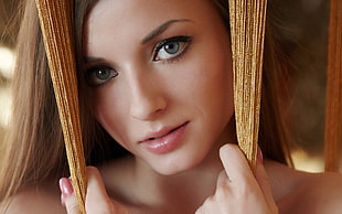 photo of woman holding brown thread decor