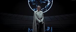 man white uniform with white cape stands near white planet hologram