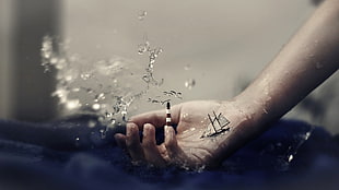 human hand, sailing ship, lighthouse, surreal, water drops
