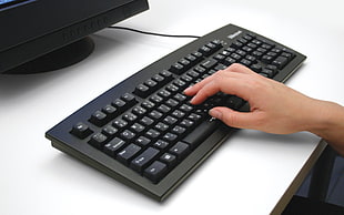 person typing on computer keyboard