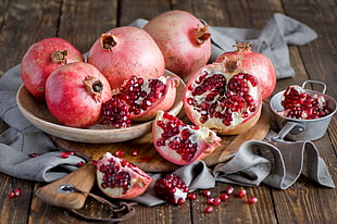 bunch of pomegranate on top of beige platter