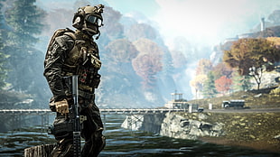 man in soldier suit near body of water during daytime