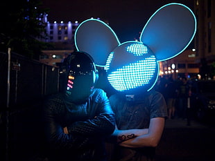 two person wearing lighted helmets
