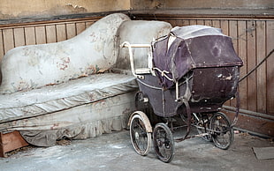baby's black and gray stroller on gray concrete flooring