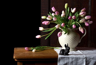 pink petaled flower arrangement in white ceramic vase