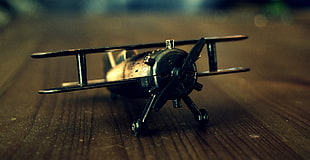 shallow photo of propeller plane toy on table