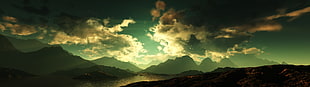 mountains under cloudy sky HD wallpaper