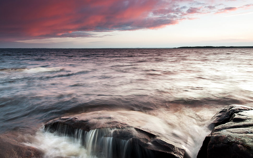 body of water under gray clouds HD wallpaper