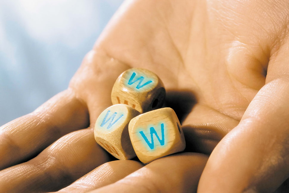 human holding three brown dice HD wallpaper