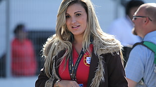 woman in brown fur-trim hooded jacket