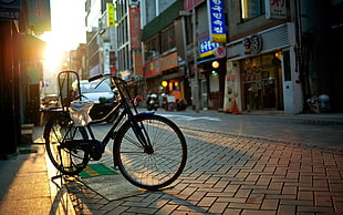 photo of black commuter bike on road