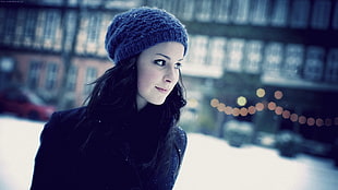 woman in black jacket and blue knitted cap during snow