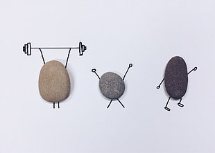 three brown and gray stone art with drawing