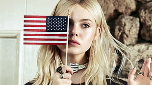 person holding mini U.S. flag, celebrity, actress, Elle Fanning, blonde