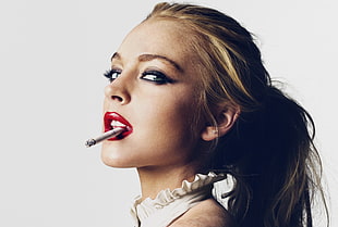 women's white halter top, red lipstick and cigarette