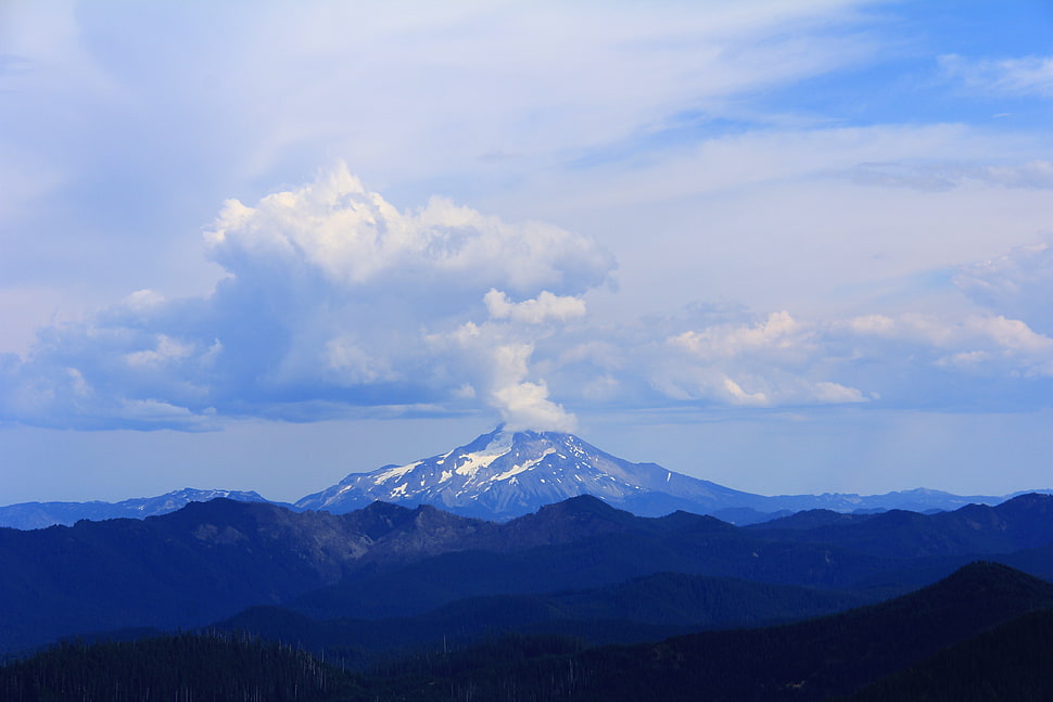 snowy mountain peak under cloudy sky HD wallpaper