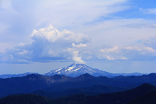 snowy mountain peak under cloudy sky HD wallpaper