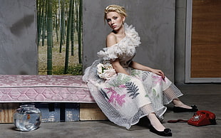 Scarlet Johanson wearing dress while sitting on mattress