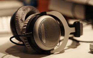 selective focus photography of gray and black corded headphones
