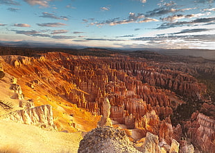 high angle photo of brown rock mountain under blue sky, bryce canyon