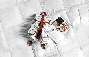 white and brown printed bucket bag on top of bed HD wallpaper